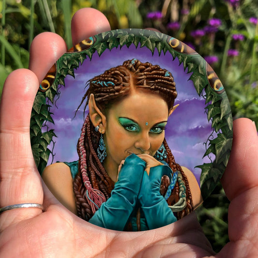 A brown-skinned female elf with long braided brown hair tied back, looks toward the viewer, hands held together in front of her mouth as though to suppress laughter. She wears turquoise elbow-length arm sleeves. She's surrounded by ivy.