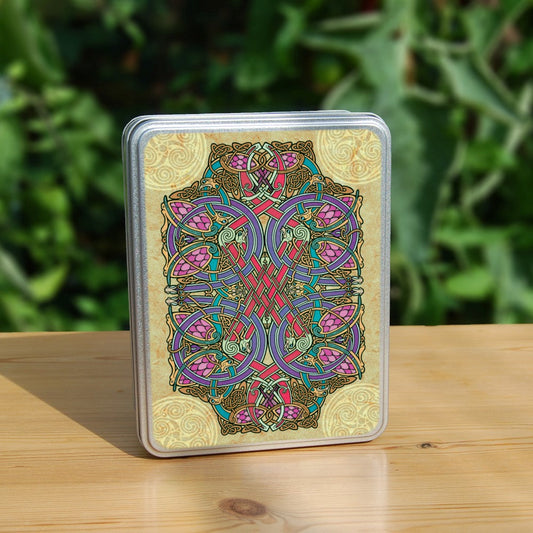 A complex and colourful Celtic design which includes four Celtic circle designs inside a central rectangle of mostly blues, reds, pinks and browns, surrounded by a dark beige background. Four beige Celtic patterns, one in each corner of the design, overlap the central rectangle.